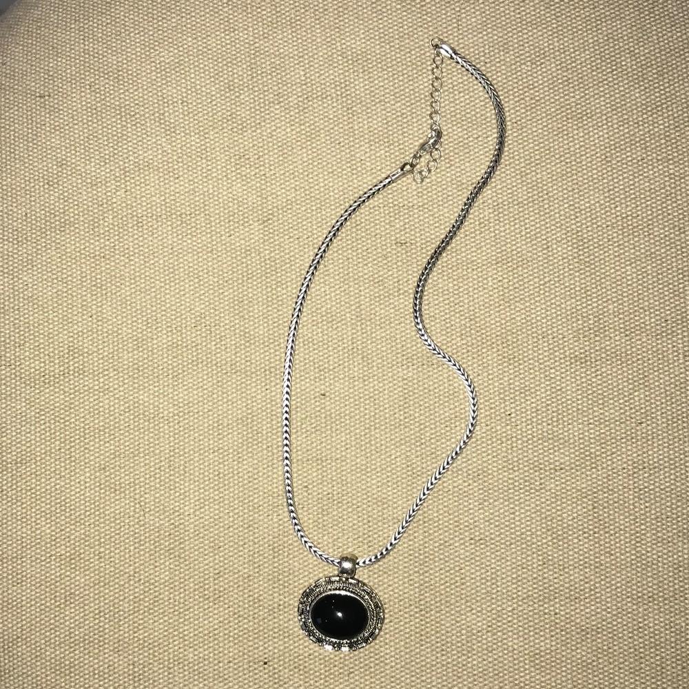 Silver tone necklace with black pendant